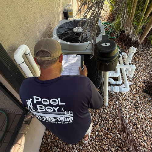 Pool Boy technician inspecting and servicing a residential pool heat pump in Charlotte County, FL.