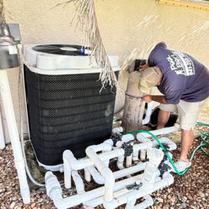 Inspecting pool equipment and heater during a 21-point pool inspection